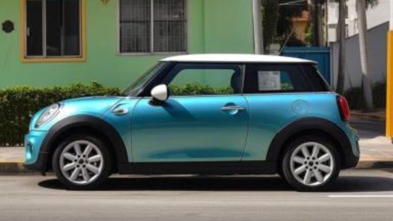 blue mini in front of house